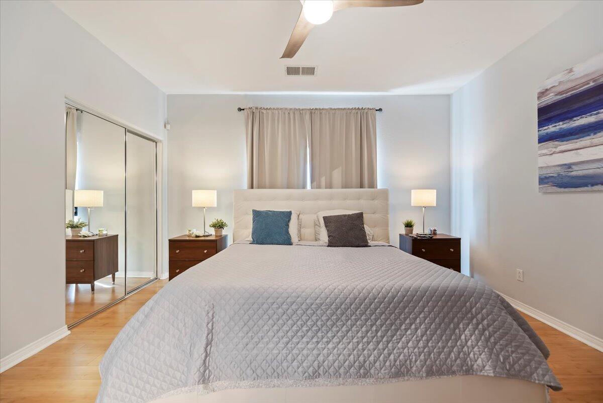 3982 Eastgate N Road Palm Springs, CA 92262 - Photo 22 of 55 a bedroom with a large bed and wooden floor