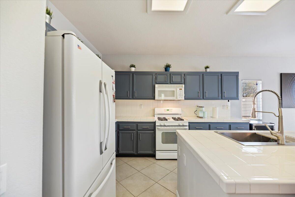 3982 Eastgate N Road Palm Springs, CA 92262 - Photo 10 of 55 a kitchen with stainless steel appliances granite countertop a sink stove and refrigerator