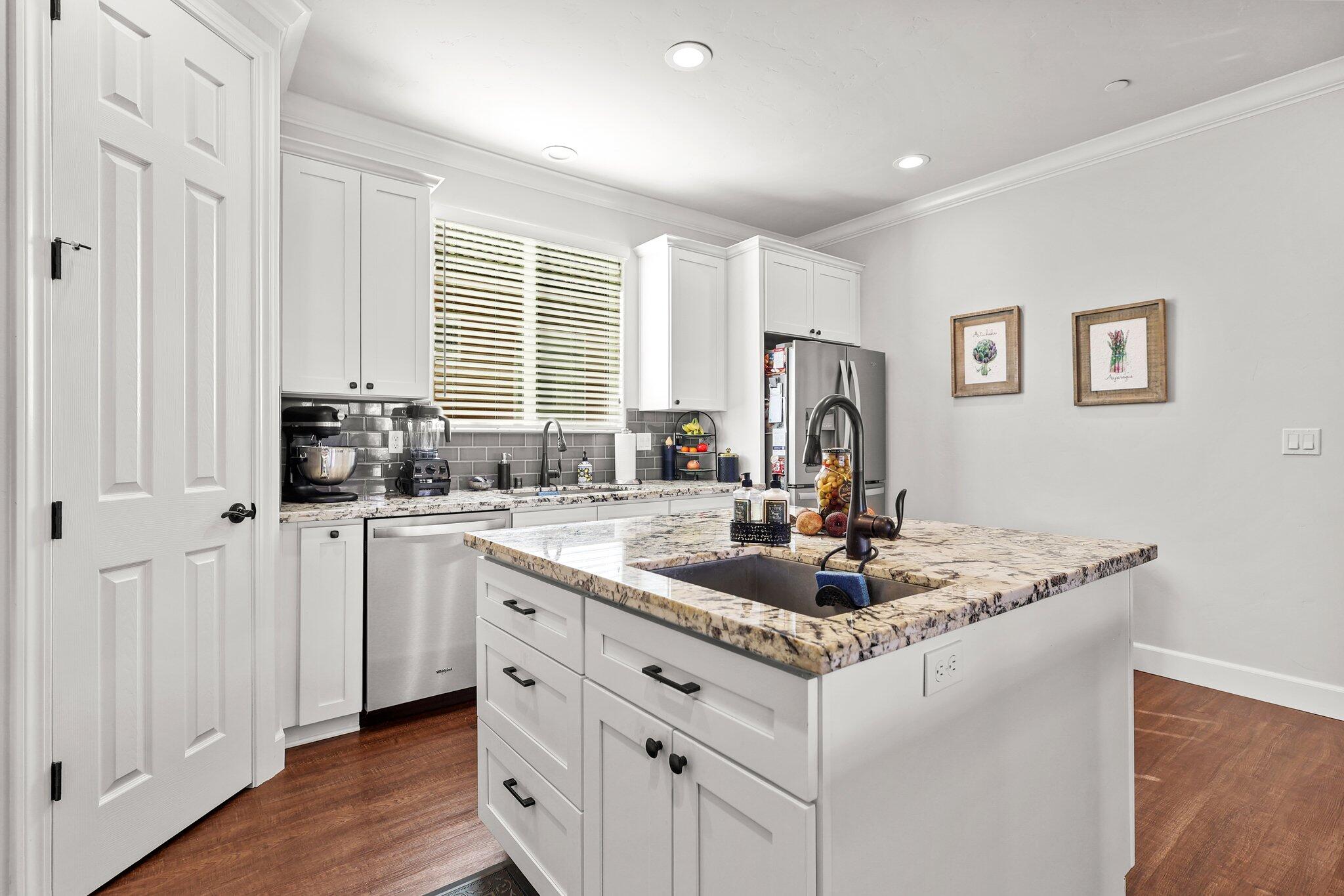 6180 Lucca Trail Redding, CA 96003 - Photo 11 of 42 a kitchen with stainless steel appliances granite countertop a sink stove and cabinets