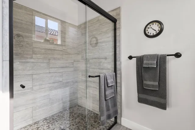 a hallway with mirror and cabinets