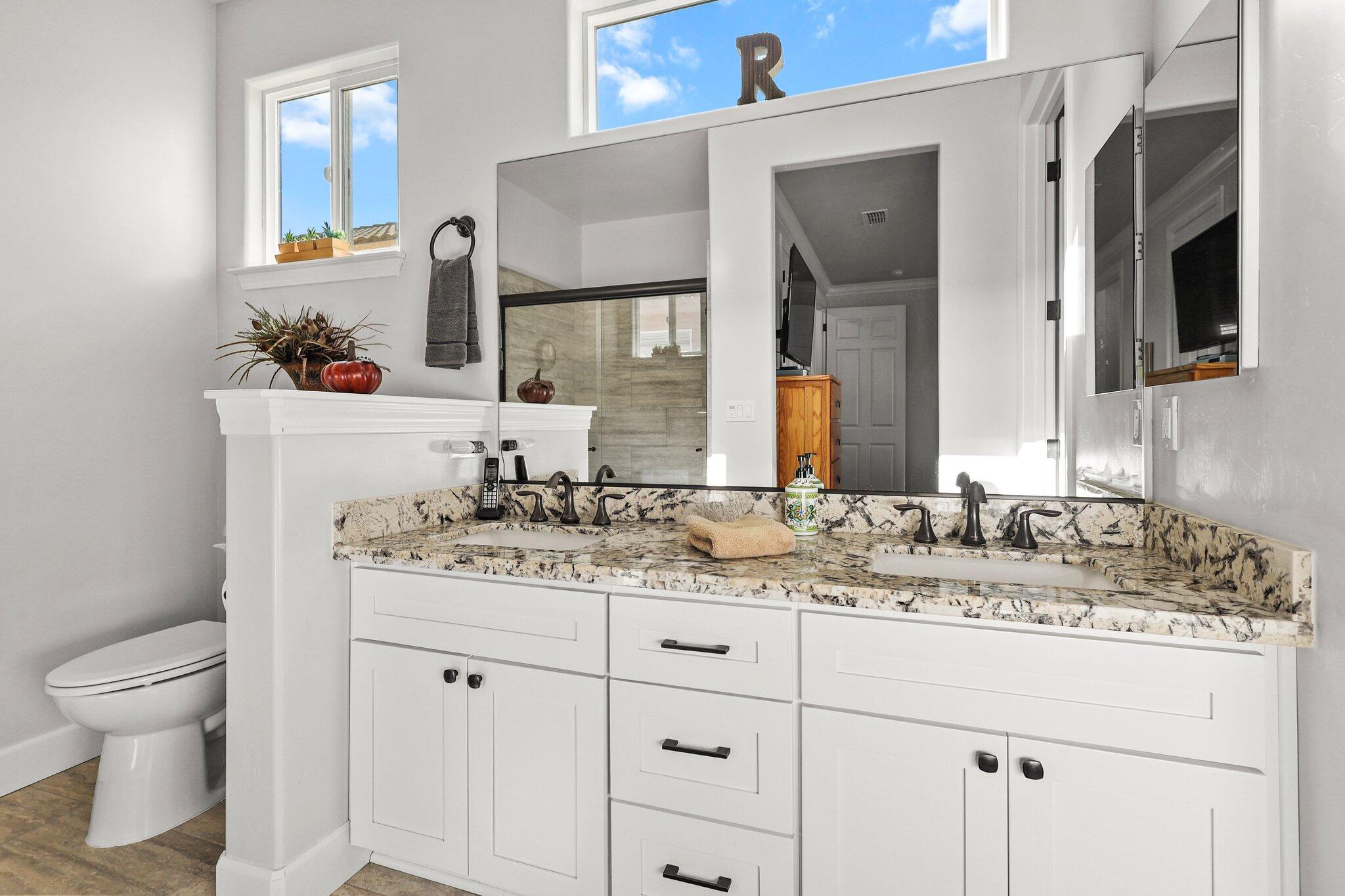 6180 Lucca Trail Redding, CA 96003 - Photo 18 of 42 a bathroom with a granite countertop sink and a mirror