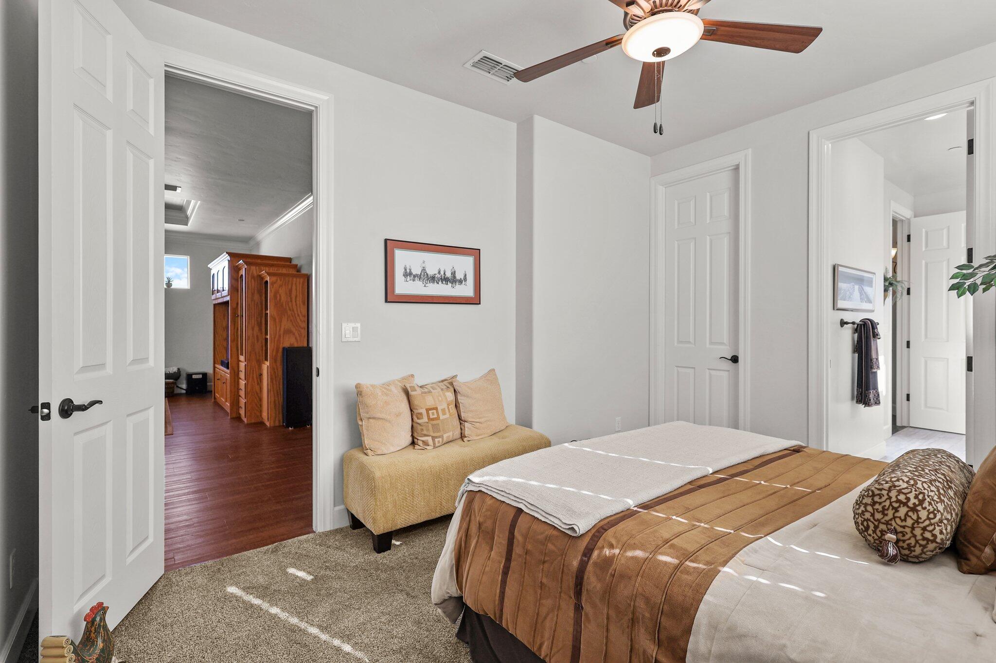 6180 Lucca Trail Redding, CA 96003 - Photo 21 of 42 a bedroom with a bed and a chandelier