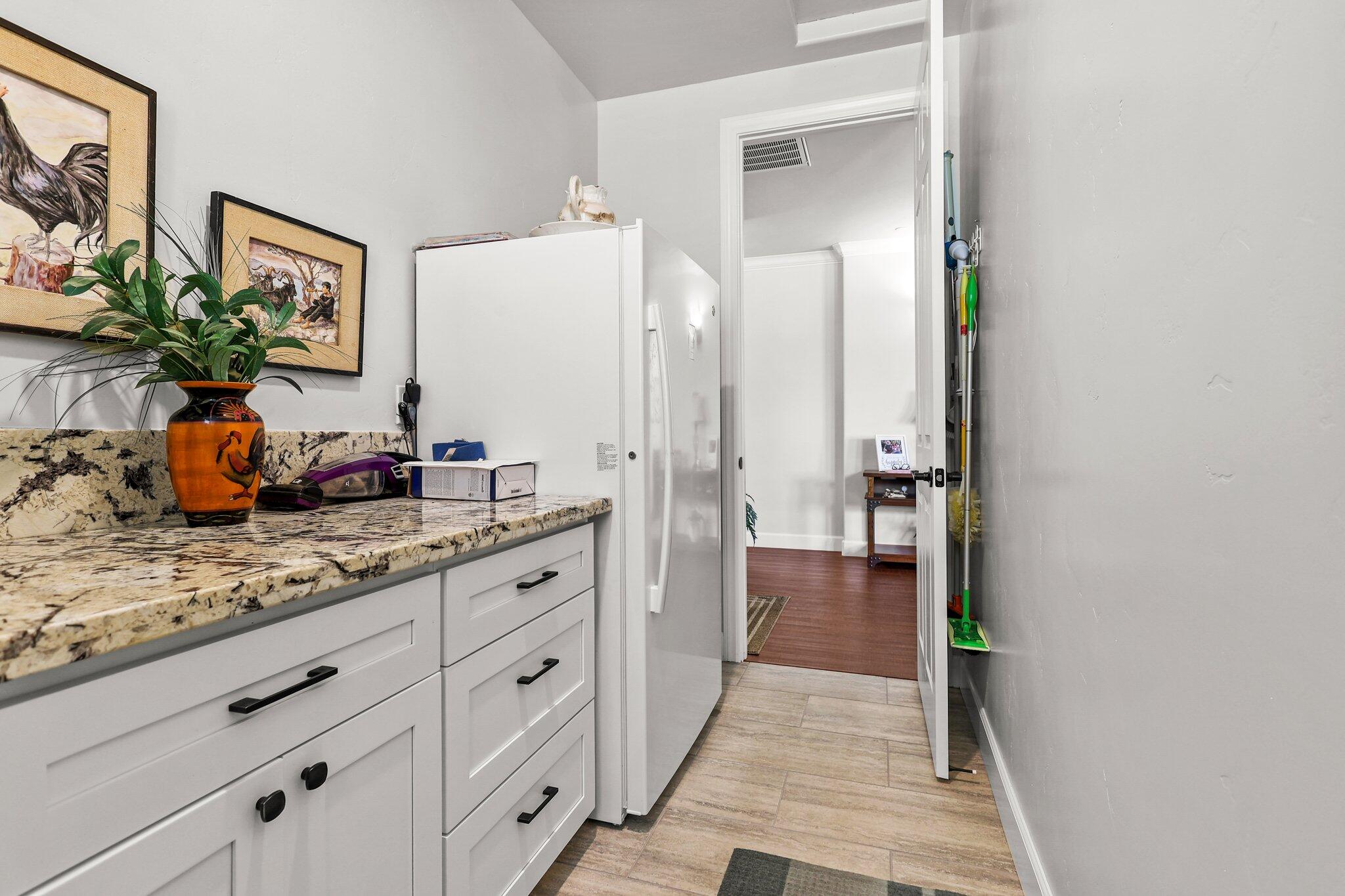 6180 Lucca Trail Redding, CA 96003 - Photo 28 of 42 a hallway with mirror and cabinets