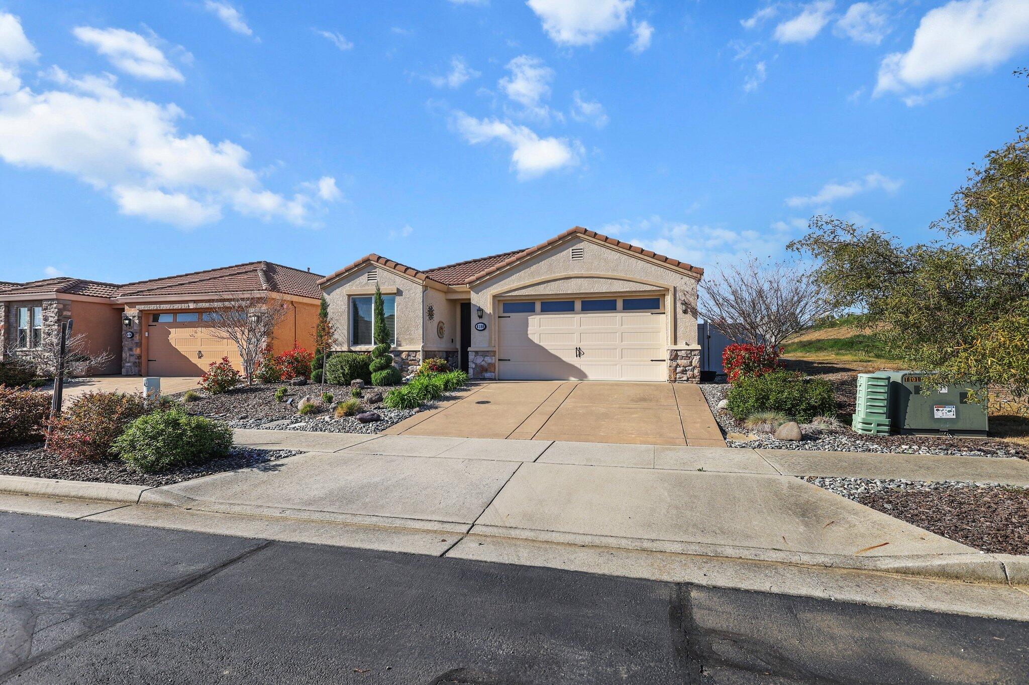 6180 Lucca Trail Redding, CA 96003 - Photo 41 of 42 a front view of a house with a yard and car parked
