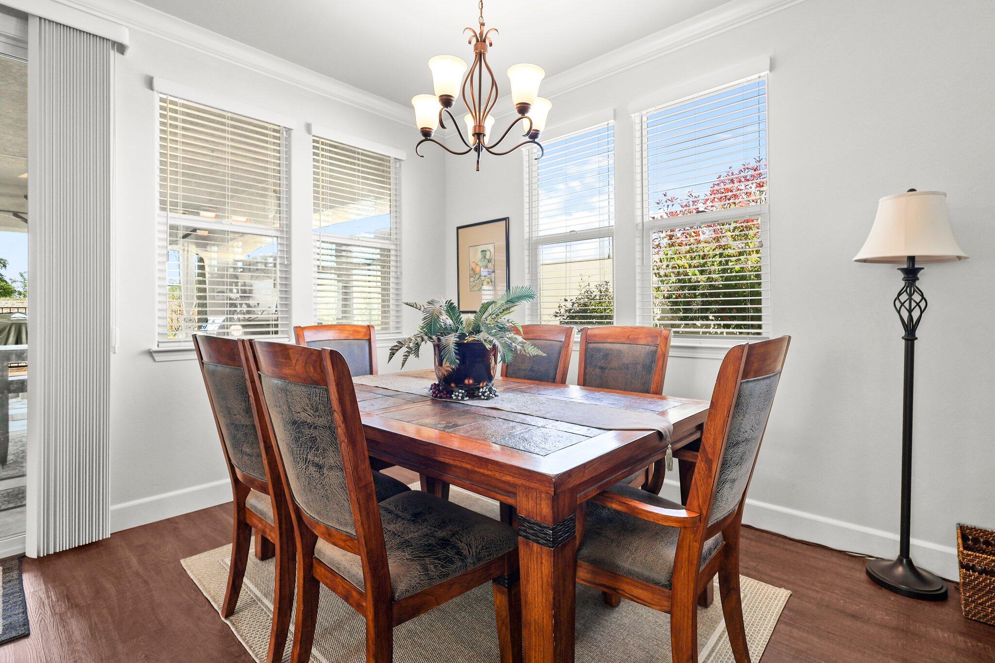 6180 Lucca Trail Redding, CA 96003 - Photo 5 of 42 a view of a dining room with furniture window and wooden floor