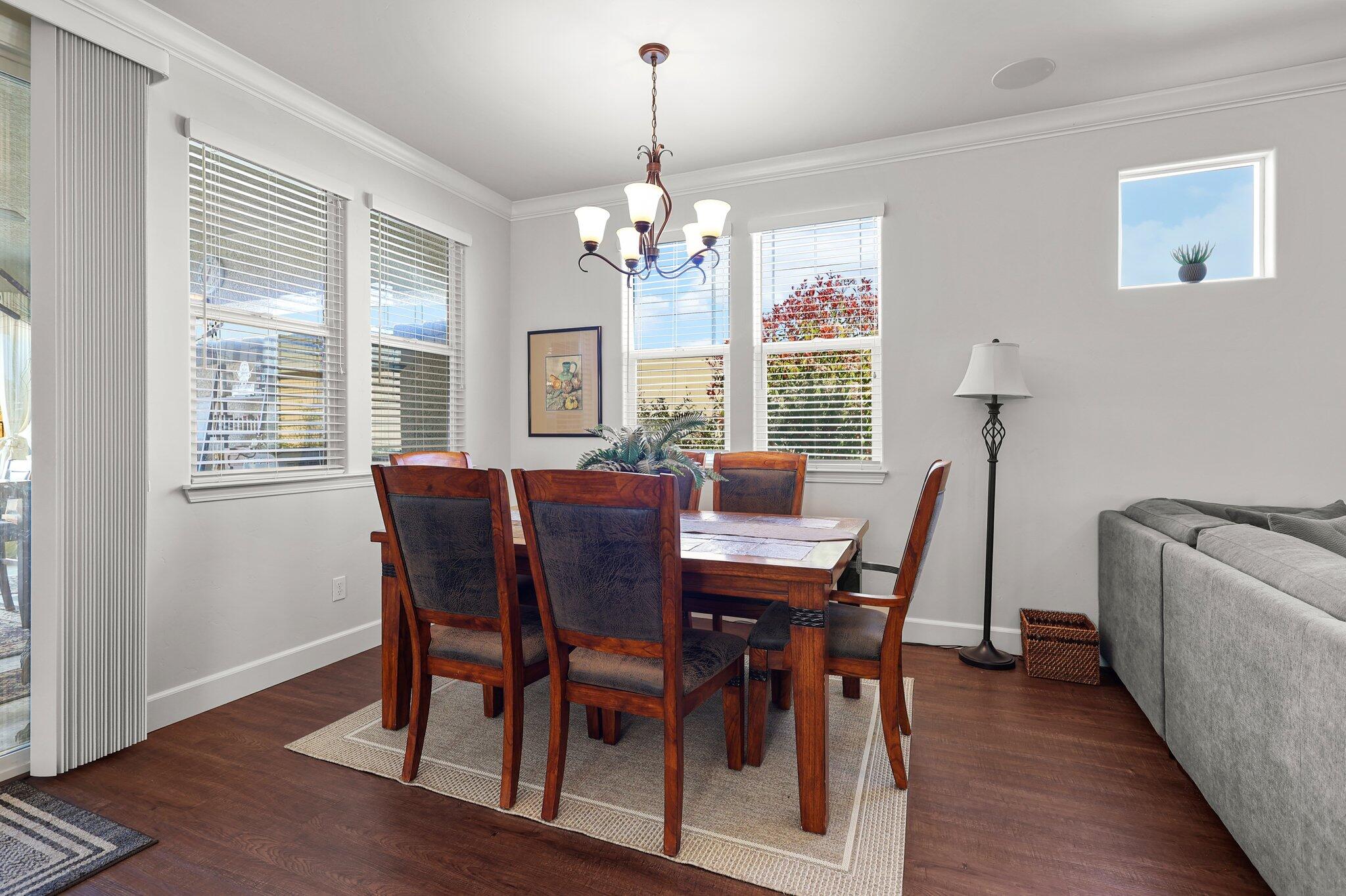 6180 Lucca Trail Redding, CA 96003 - Photo 6 of 42 a view of a dining room with furniture a chandelier and wooden floor