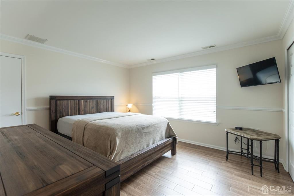 4 Merlot Court Monroe Township, NJ 08831 - Photo 14 of 17 a bedroom with a bed and a flat screen tv