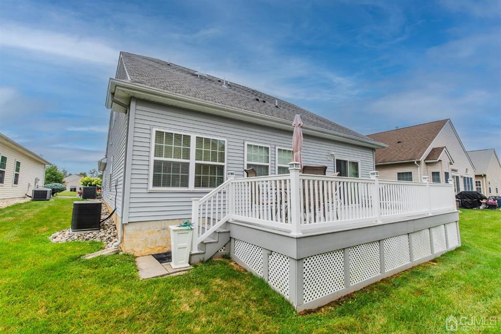 4 Merlot Court Monroe Township, NJ 08831 - Photo 16 of 17 a view of house with a yard and deck