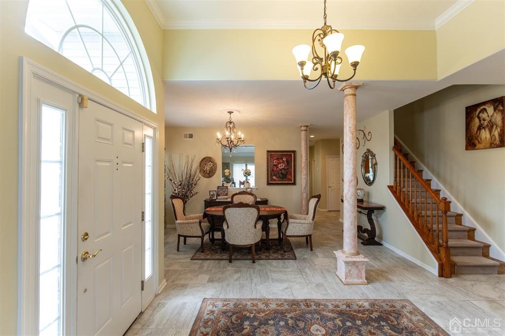 4 Merlot Court Monroe Township, NJ 08831 - Photo 3 of 17 a living room with furniture and a chandelier