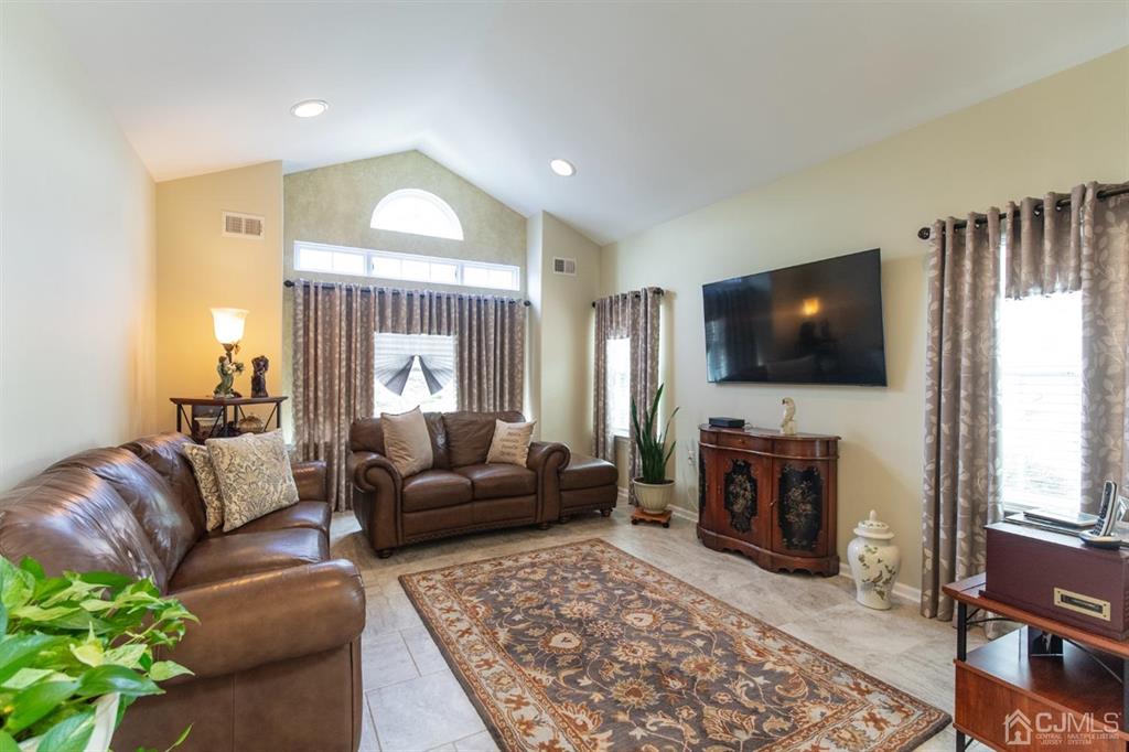 4 Merlot Court Monroe Township, NJ 08831 - Photo 4 of 17 a living room with furniture and a flat screen tv