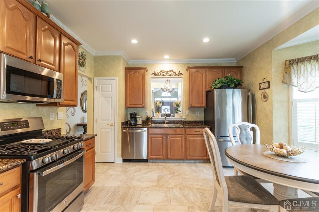 4 Merlot Court Monroe Township, NJ 08831 - Photo 5 of 17 a kitchen with stainless steel appliances granite countertop a stove a sink and a refrigerator