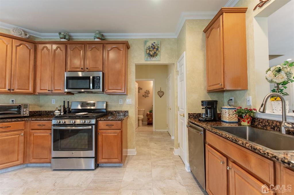 4 Merlot Court Monroe Township, NJ 08831 - Photo 6 of 17 a kitchen with stainless steel appliances a stove a sink a microwave and cabinets