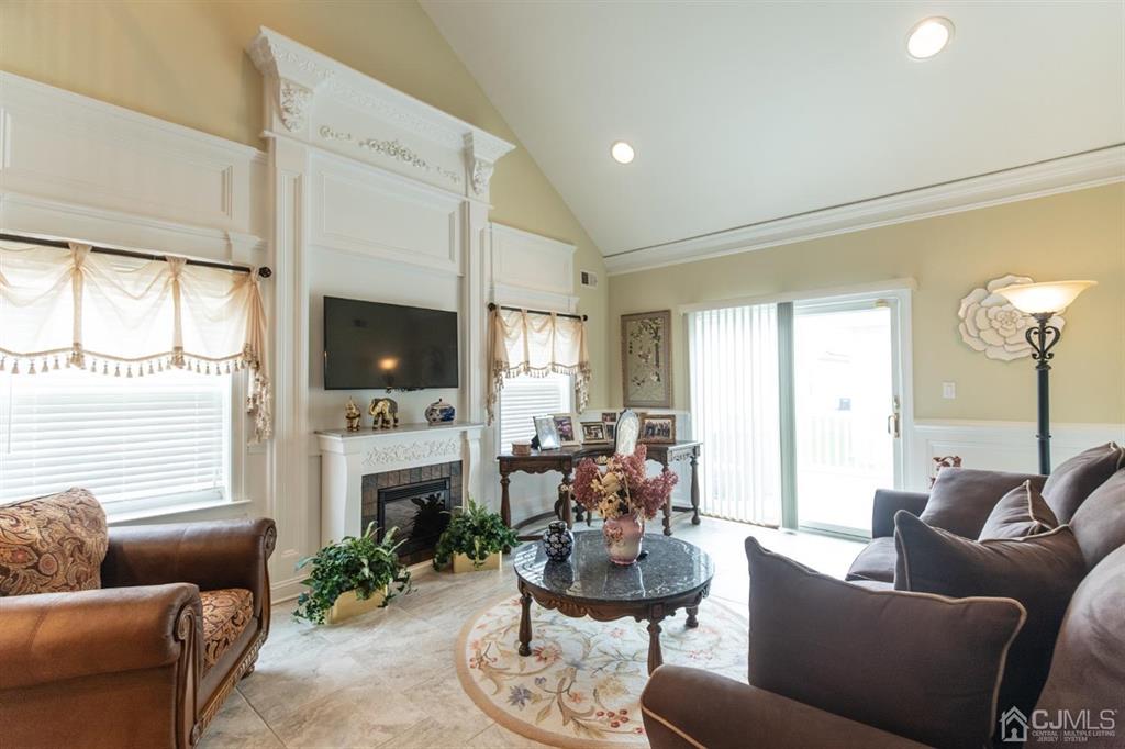 4 Merlot Court Monroe Township, NJ 08831 - Photo 7 of 17 a living room with furniture a flat screen tv and a fireplace