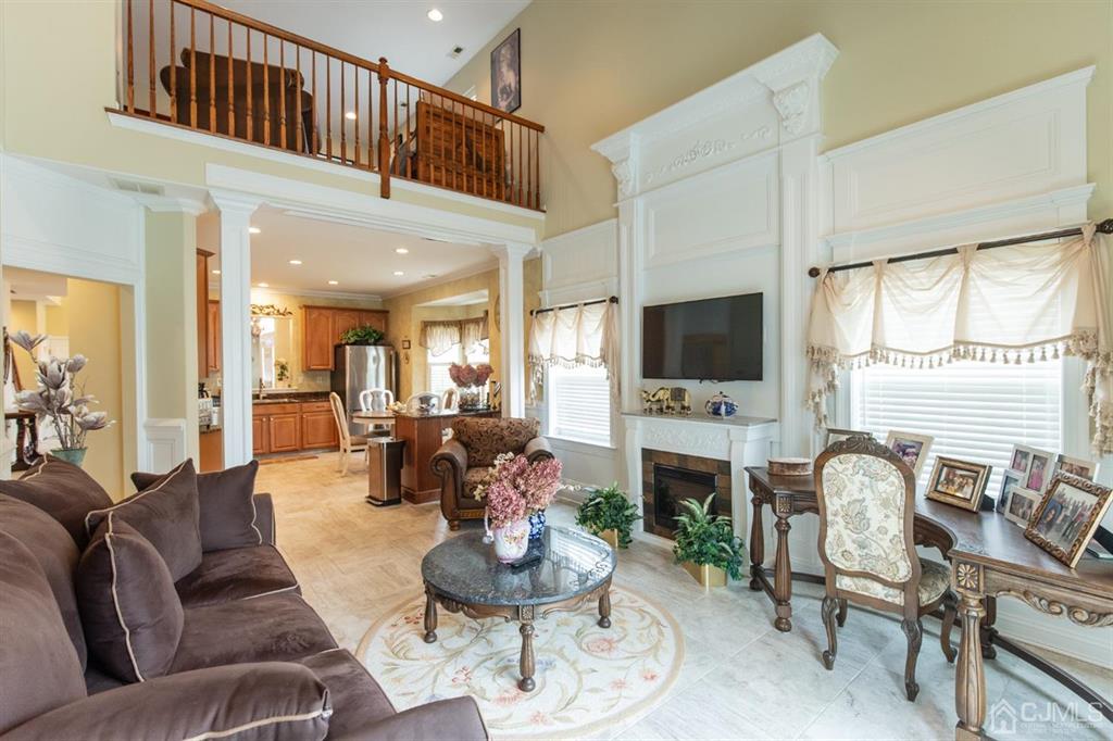 4 Merlot Court Monroe Township, NJ 08831 - Photo 8 of 17 a living room with fireplace furniture and a flat screen tv
