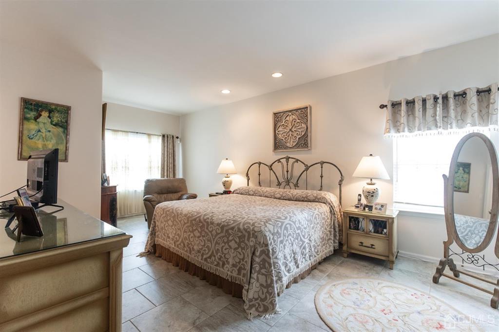 4 Merlot Court Monroe Township, NJ 08831 - Photo 9 of 17 a bedroom with bed a mirror and window