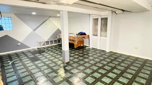 a living room with a bed and a cabinets