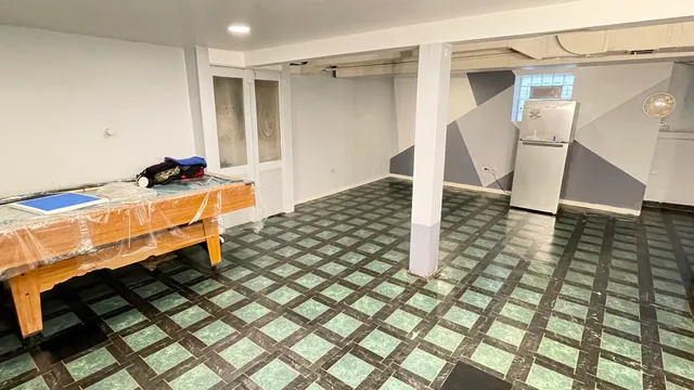 a room with gym equipment and tub