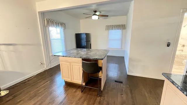 a dining room with table chairs and wooden floor