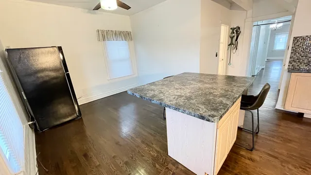a kitchen with granite countertop sink refrigerator and microwave