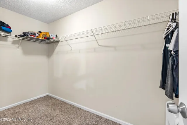 a bedroom with a bed dresser and a window