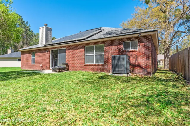a bathroom with a granite countertop sink a mirror a bathtub and shower