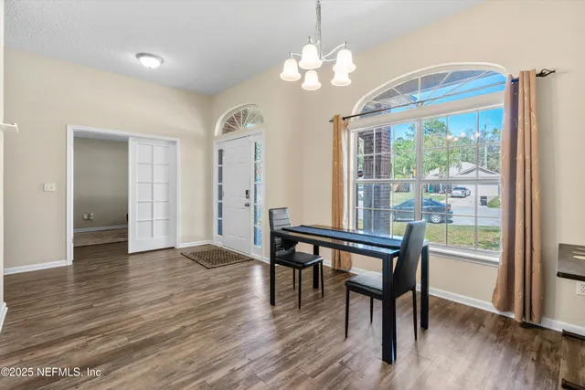 a view of a dining room with furniture window and wooden floor