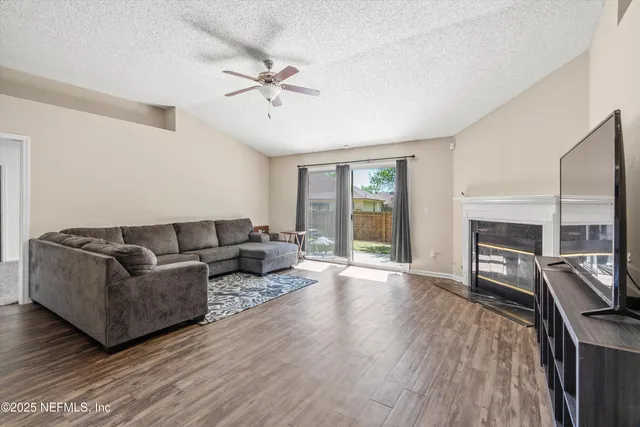 a living room with furniture and a wooden floor