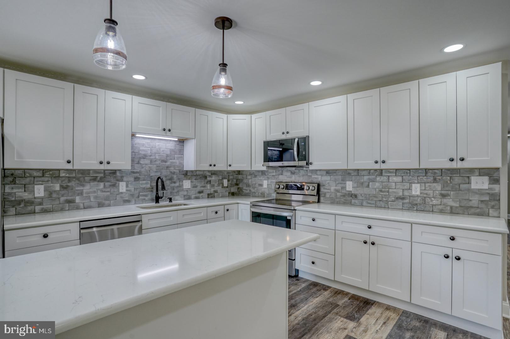 67 Morgans Choice Road Camden Wyoming, DE 19934 - Photo 19 of 56 a kitchen with cabinets appliances a sink and a counter top space