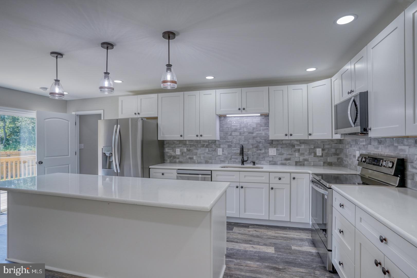 67 Morgans Choice Road Camden Wyoming, DE 19934 - Photo 20 of 56 a kitchen with stainless steel appliances granite countertop a sink a stove and a refrigerator