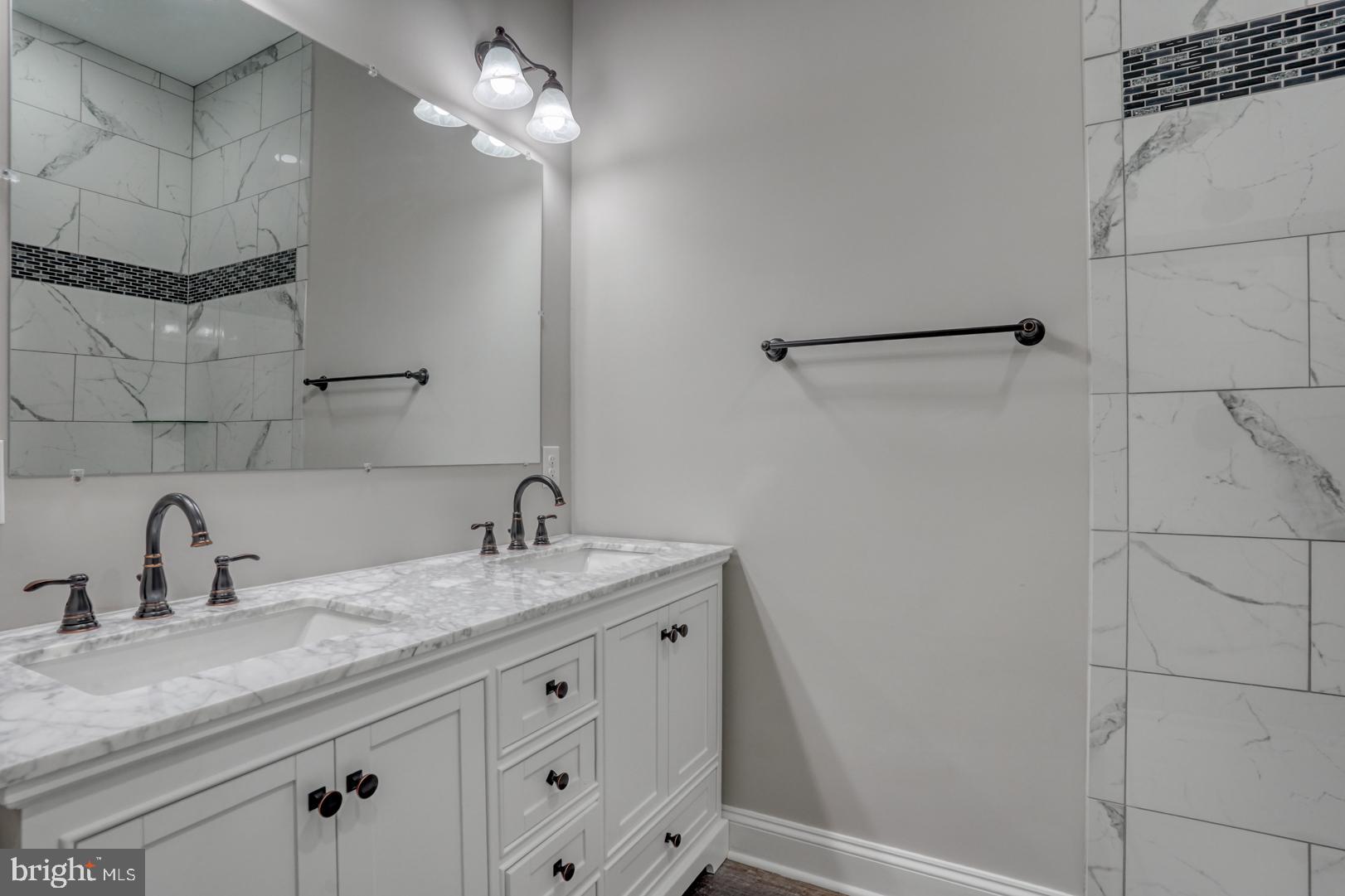 67 Morgans Choice Road Camden Wyoming, DE 19934 - Photo 27 of 56 a bathroom with a sink and vanity