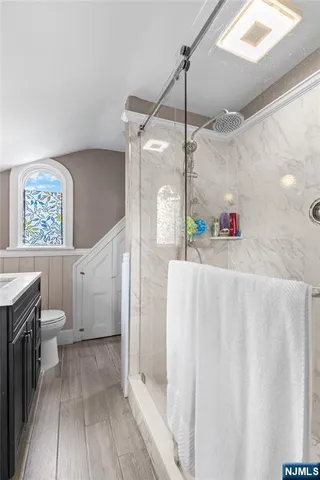 a bathroom with a sink a mirror and a toilet