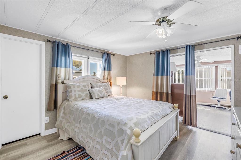 1100 South Belcher Road, Unit 502 Largo, FL 33771 - Photo 24 of 51 a bedroom with a large bed and a chandelier