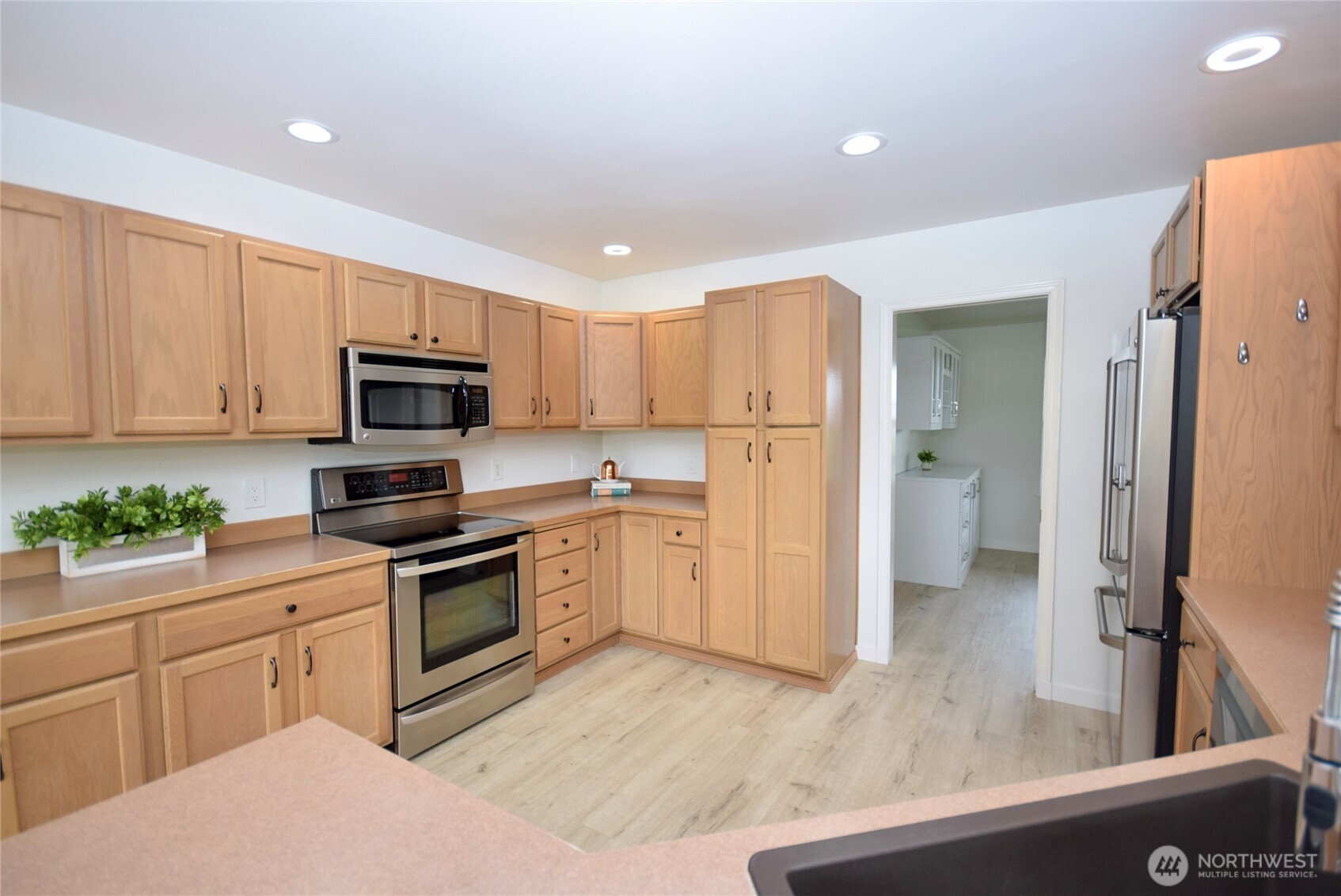 71 John Carl Road Sequim, WA 98382 - Photo 11 of 37 a kitchen with white cabinets and stainless steel appliances