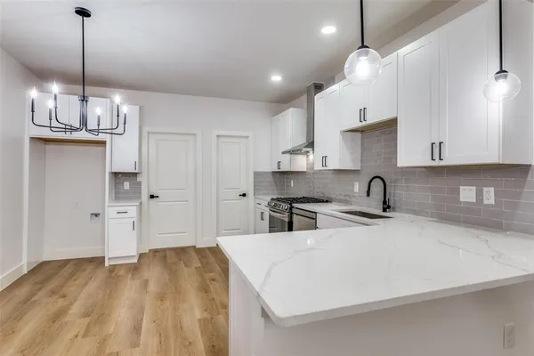 a kitchen with kitchen island a sink stainless steel appliances and cabinets