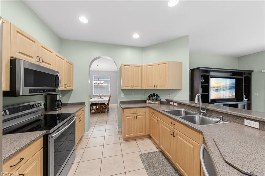 21632 Windham Run Estero, FL 33928 - Photo 14 of 50 a kitchen with a sink stove and cabinets