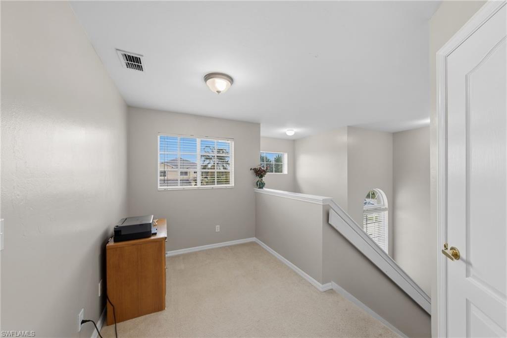 21632 Windham Run Estero, FL 33928 - Photo 21 of 50 a view of a hallway with windows