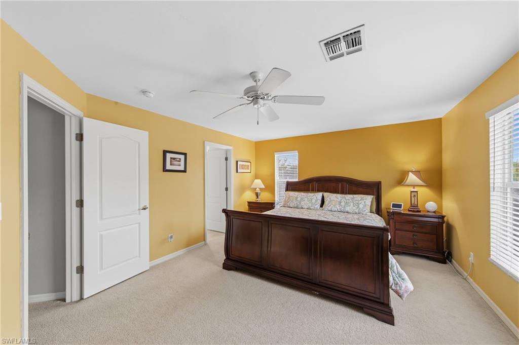 21632 Windham Run Estero, FL 33928 - Photo 23 of 50 a bed room with a bed and a chandelier