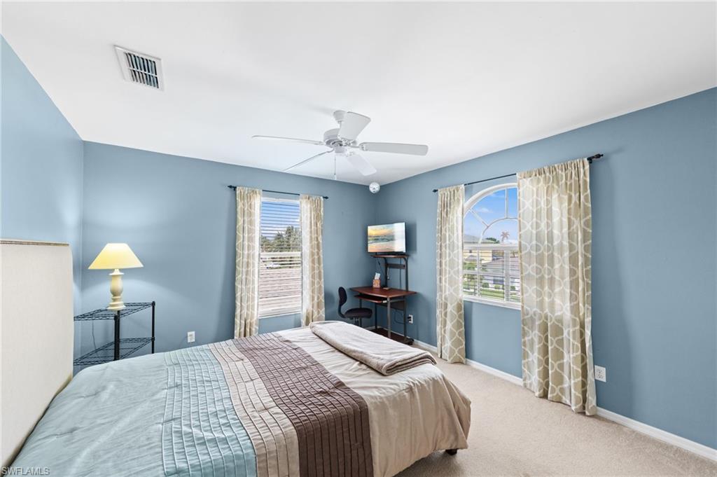 21632 Windham Run Estero, FL 33928 - Photo 27 of 50 a bedroom with a bed and a chandelier