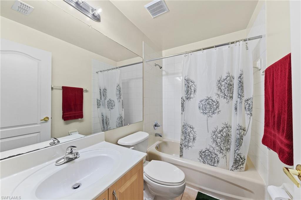 21632 Windham Run Estero, FL 33928 - Photo 29 of 50 a bathroom with a sink a toilet and shower curtain