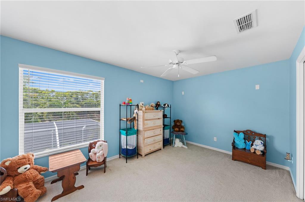 21632 Windham Run Estero, FL 33928 - Photo 30 of 50 a bedroom with furniture and a large window