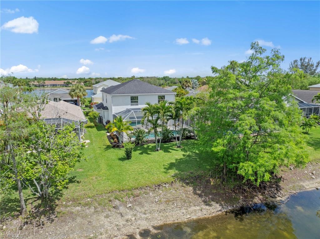 21632 Windham Run Estero, FL 33928 - Photo 39 of 50 a view of a garden with a building in the background