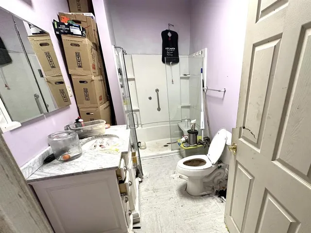 a bathroom with a sink toilet and shower