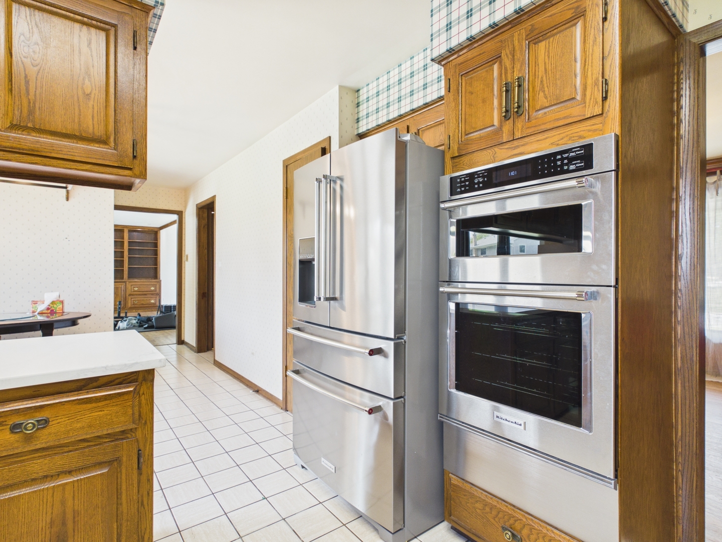 6723 Kingswood Road Willowbrook, IL 60527 - Photo 16 of 51 a kitchen with stainless steel appliances granite countertop a refrigerator and cabinets