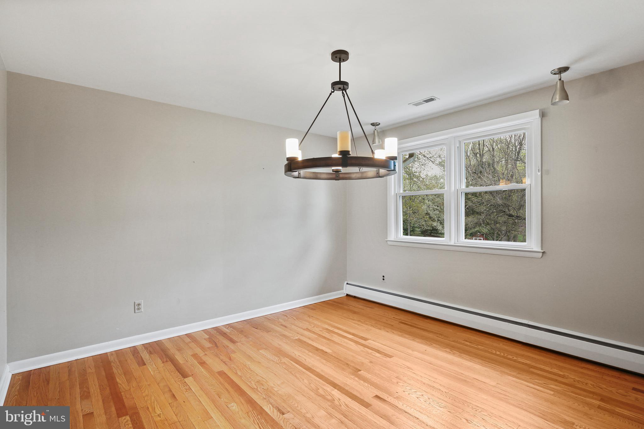 9826 Fox Hill Road Perry Hall, MD 21128 - Photo 11 of 45 a view of empty room with wooden floor and windows