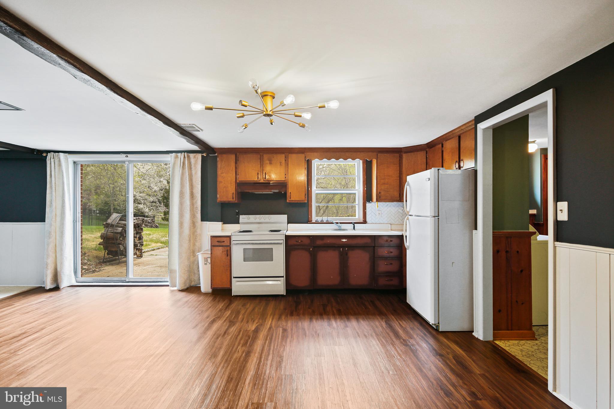 9826 Fox Hill Road Perry Hall, MD 21128 - Photo 25 of 45 a kitchen with refrigerator cabinets and wooden floor