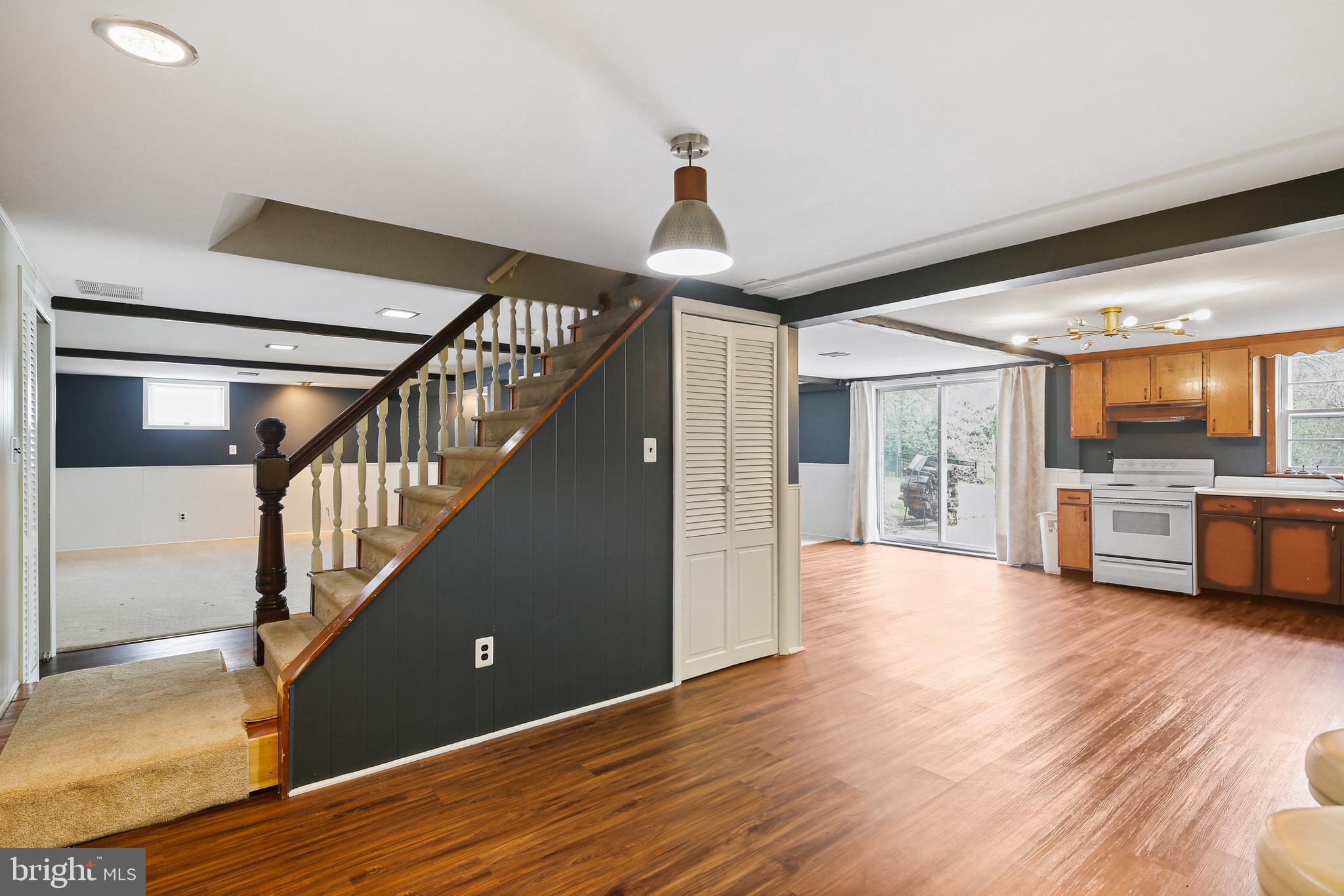 9826 Fox Hill Road Perry Hall, MD 21128 - Photo 26 of 45 a view of a hallway with wooden floor staircase and a kitchen