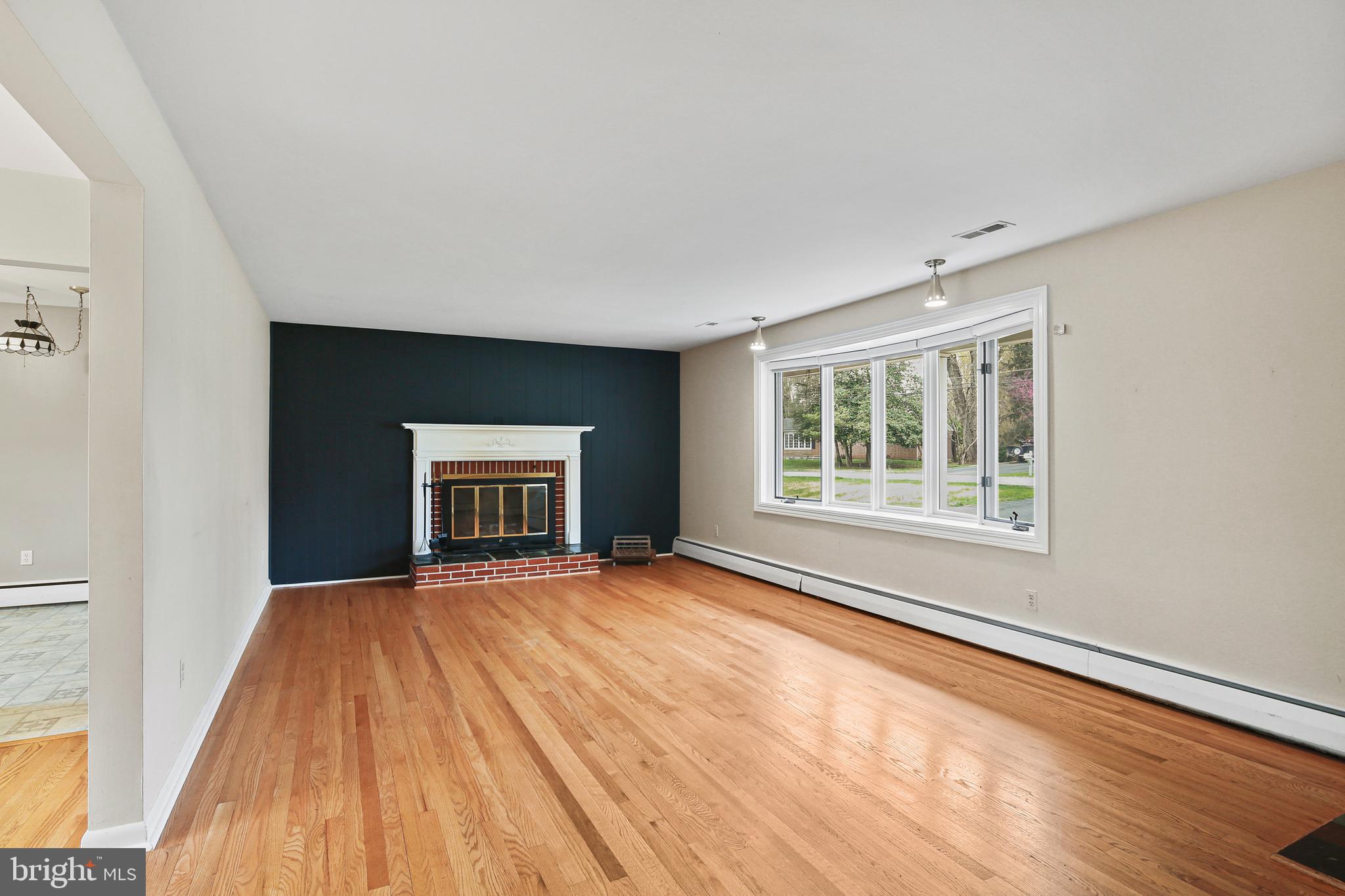 9826 Fox Hill Road Perry Hall, MD 21128 - Photo 8 of 45 a view of an empty room with a window and wooden floor