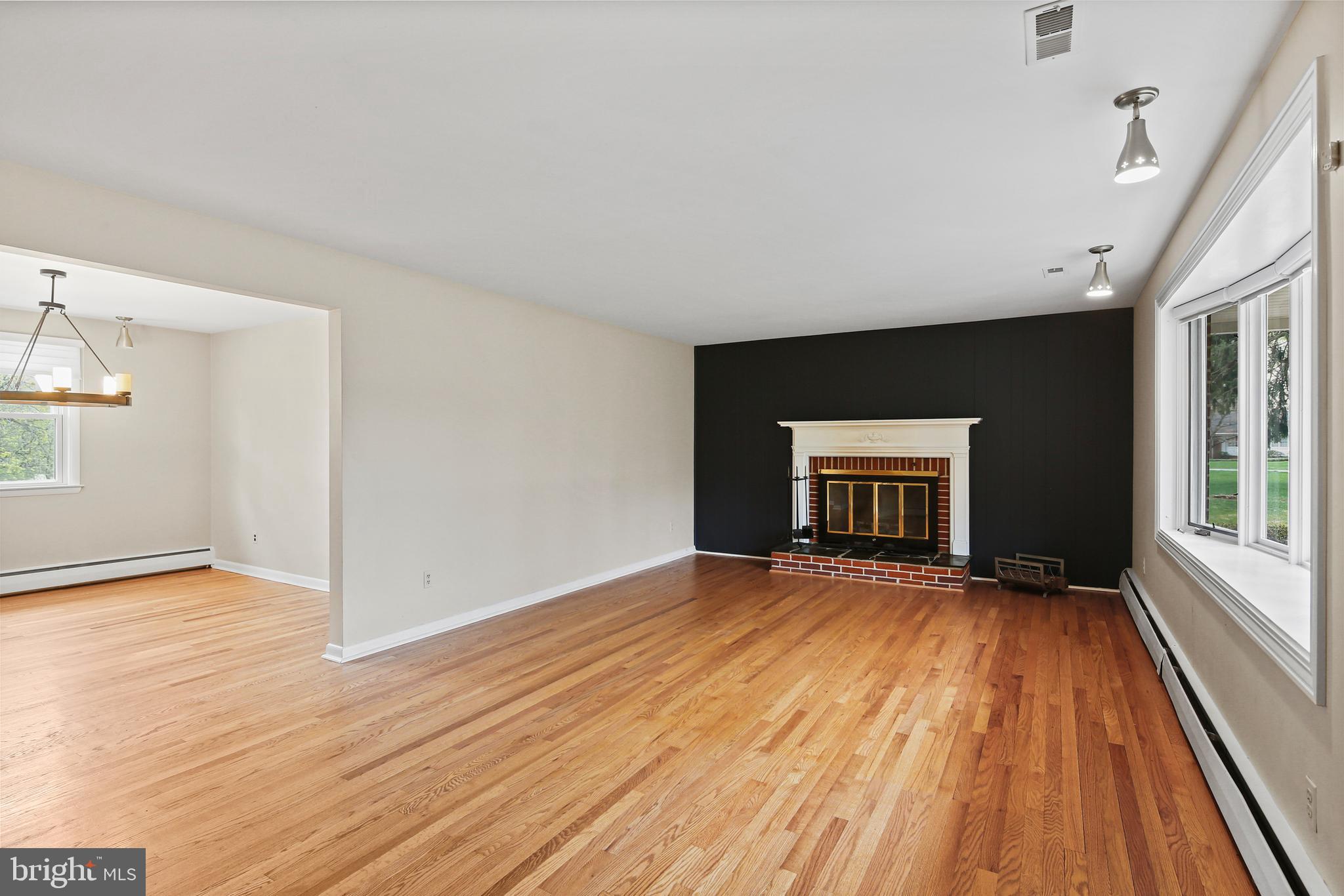 9826 Fox Hill Road Perry Hall, MD 21128 - Photo 10 of 45 a view of an empty room with a fireplace and a window
