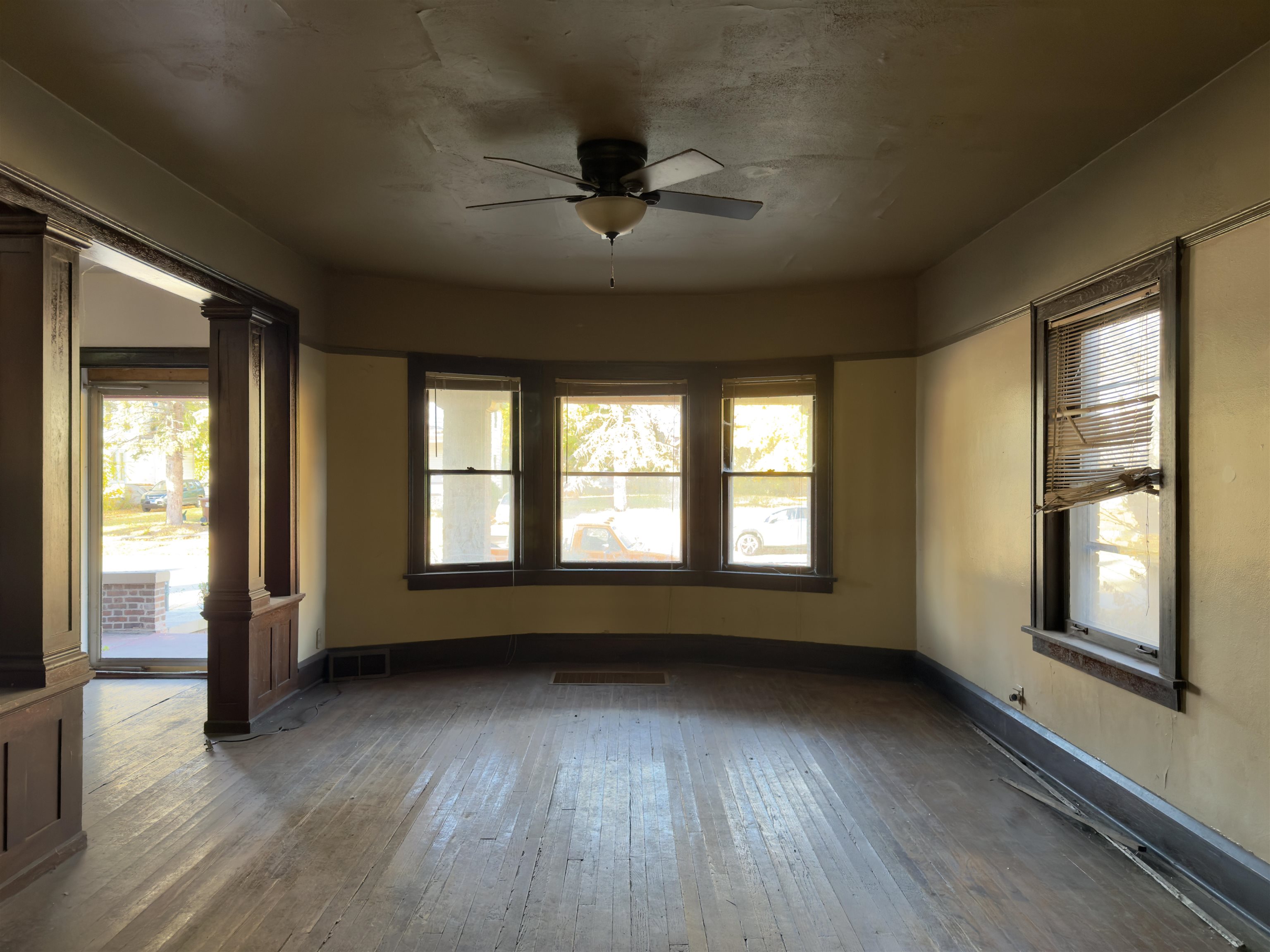 1315 4th Avenue Rockford, IL 61104 - Photo 2 of 14 a view of an empty room with wooden floor and a window