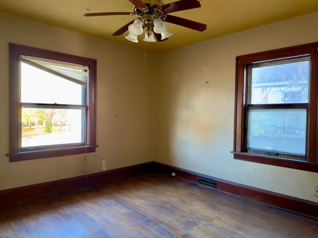 a view of a room with a window and a fan
